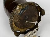 a brown bottle with a cord plugged into it