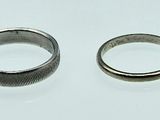 two rings that are sitting on a white surface