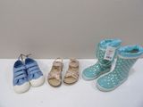 three pairs of baby shoes are lined up on a white surface