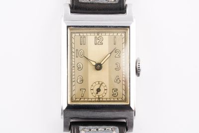 une montre posée sur une surface blanche