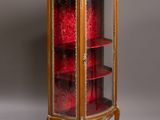 an antique display cabinet with a glass door and shelves
