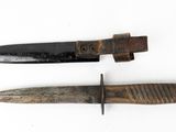 two knives on a white surface one has a brown handle and the other has a black handle