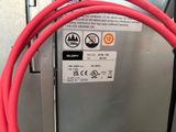 a close up of a red cable connected to a machine