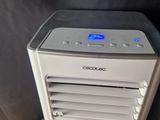 a small air conditioner sitting on top of a wooden table