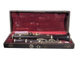 a black and silver clarinet in a case on a white background