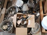 a pile of silverware sitting on top of a pallet