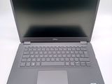 a dell laptop computer sitting on a white surface