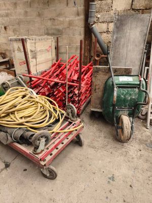 a cart full of hoses next to a pile of other equipment
