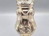 a silver vase with a lid sitting on top of a table
