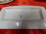 a white platter with a green design on it