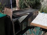 an old oven sitting on a table outside in the yard