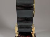 a black and gold clock sitting on top of a table