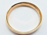 a close up of a gold ring on a white surface
