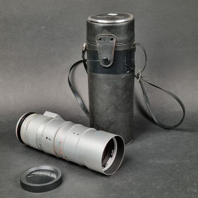 a camera lens and a leather case on a table