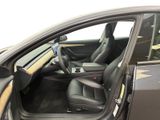 the interior of a car with the door open and the driver ' s seat down