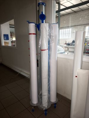 two rolls of white paper on the floor next to a window