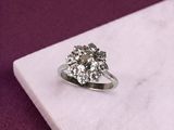 an image of a diamond ring sitting on a marble slab