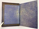 a picture of a hand holding a book open to reveal a picture