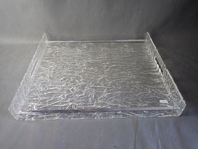 a clear plastic tray on a table with a black background