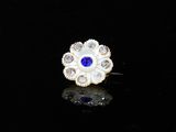 a close up of a ring with a blue stone in it