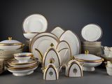 many different types of plates and bowls on the table