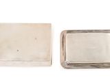 a silver plate and a silver tray on a white surface