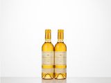 two bottles of wine sitting on top of a table next to each other