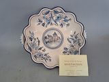a blue and white plate with a picture of a castle on it