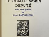 an old book with a picture of a house in the middle of it