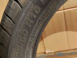 the tire of a car is sitting on the floor in front of a cardboard box