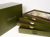 four boxes with silverware in them on a white surface
