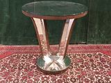 a small table with a glass top on a rug