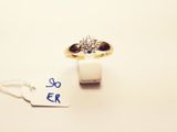 a gold ring with a diamond on it and a price tag