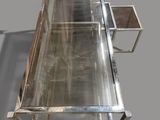 a glass table with a metal base and a glass top