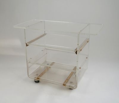 a clear plastic cart with three shelves on it