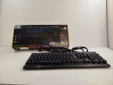 a computer keyboard and a mouse on a white table