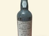 an old bottle of rum sitting on top of a white surface