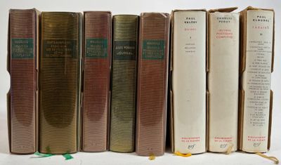 several old books are lined up in a row on a white surface