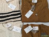 three sweaters with tags on them sitting next to each other