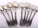 six forks and spoons are arranged in a row on a white surface
