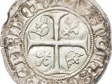 an old silver coin with a cross on it