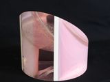 a pink object that is sitting on a black surface