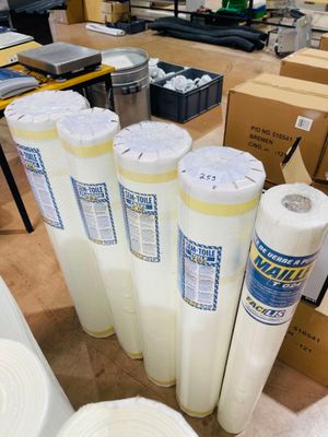 many rolls of white paper sitting on a table