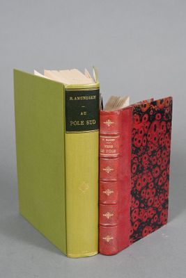 two books sitting next to each other on a gray surface