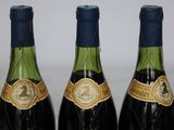 three bottles of wine sitting next to each other on a table