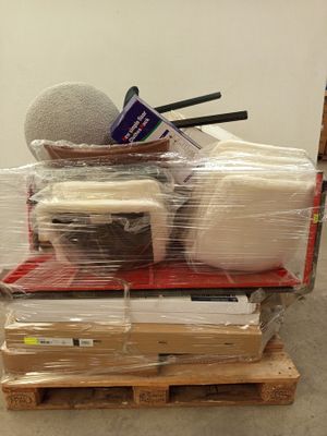 a pile of items on a pallet in a room