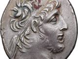 a close up of a silver coin with a head of a man