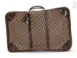 une image représentant une valise marron et noire munie d'une poignée marron
