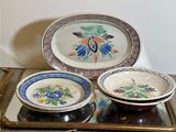 three plates and a bowl on a tray on a table