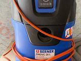 a blue and black vacuum sitting on top of a box